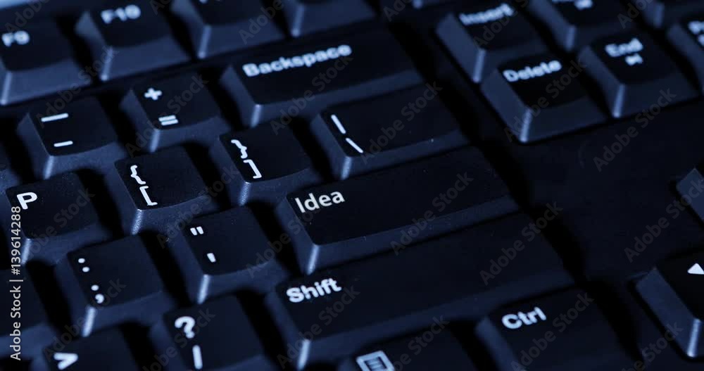 Close up of finger pressing an idea button on the computer keyboard Close up of finger pressing an idea button on the computer keyboard