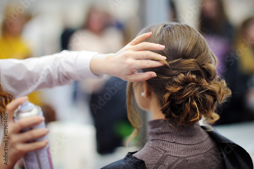 Young woman getting her hair done before party