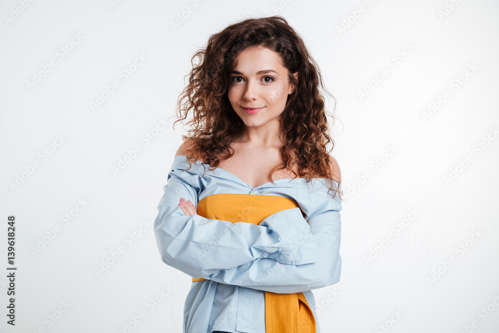 Portrait of a cheerful smiling woman standing with arms folded Portrait of a cheerful smiling woman standing with arms folded