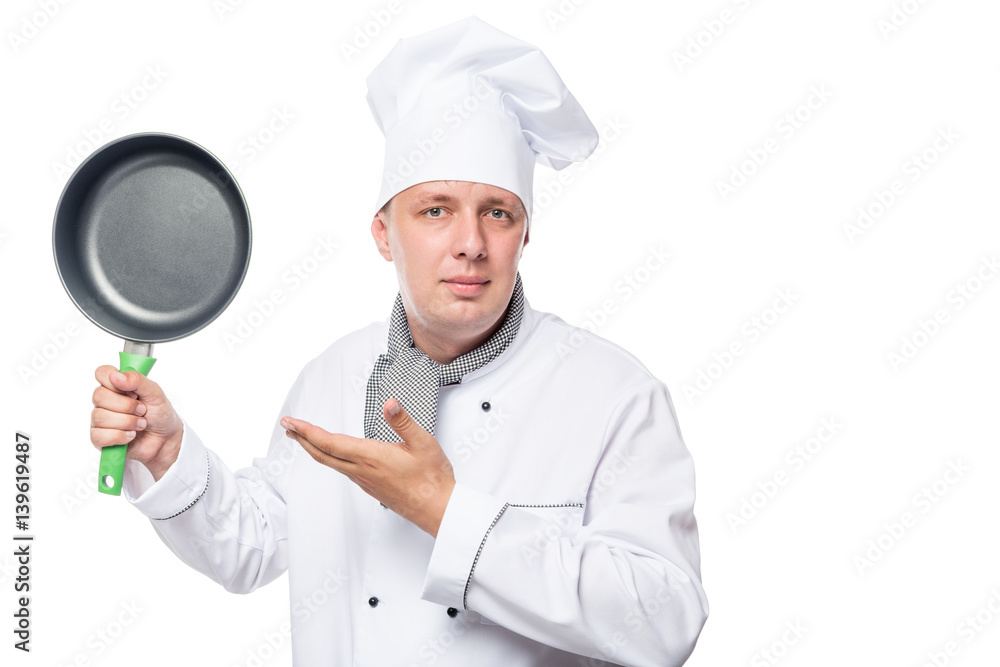 young chef and a frying pan, a portrait on a white background in studio young chef and a frying pan, a portrait on a white background in studio