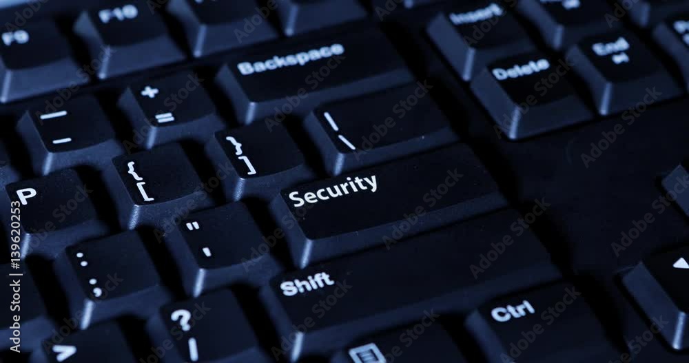 Close up of a male hand pressing a Security button on the computer keyboard Close up of a male hand pressing a Security button on the computer keyboard