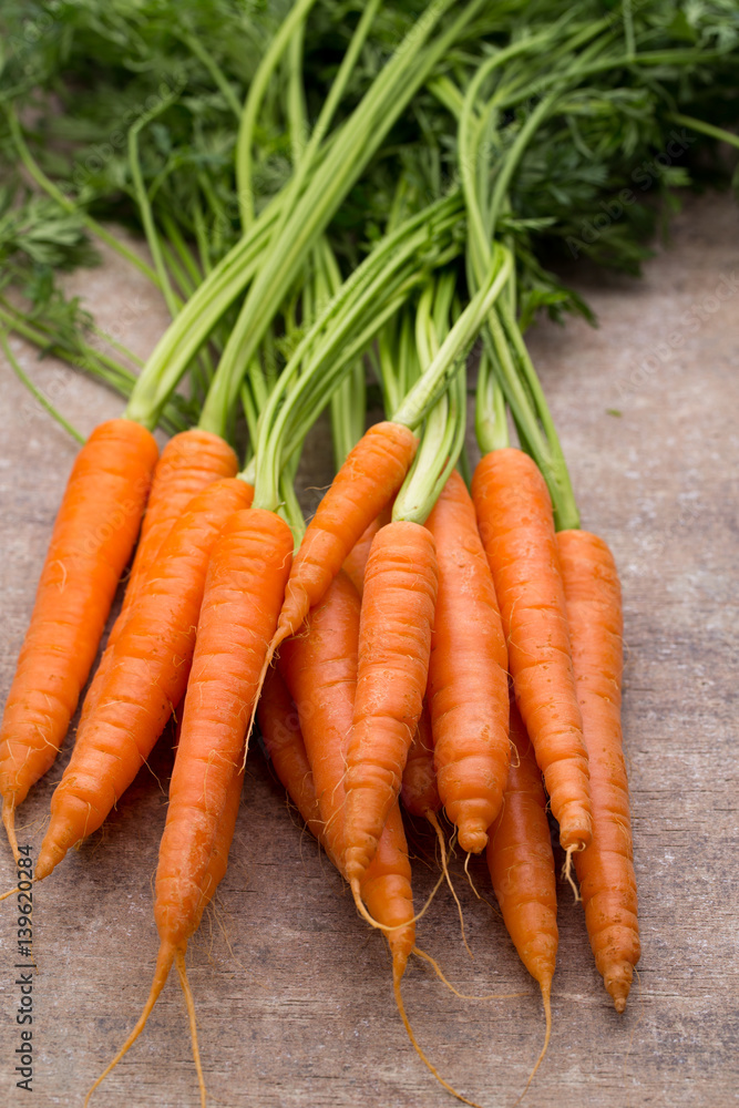Fresh and sweet carrot on a grey wooden table. Fresh and sweet carrot on a grey wooden table.