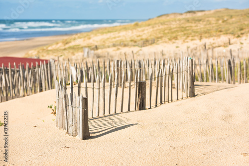 Fototapeta Naklejka Na Ścianę i Meble -  Wooden fence on Atlantic beach in France