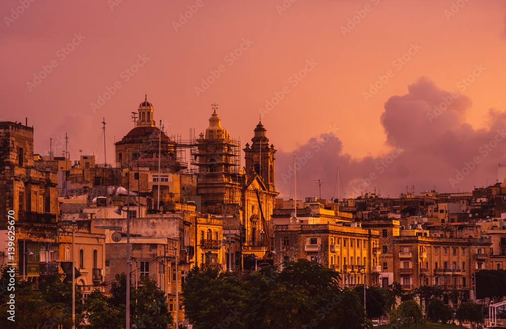 Pink evening in Cospicua and view to Immaculate Conception Church