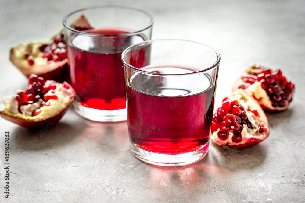 ripe pomergranate and glass of juice on table background ripe pomergranate and glass of juice on table background