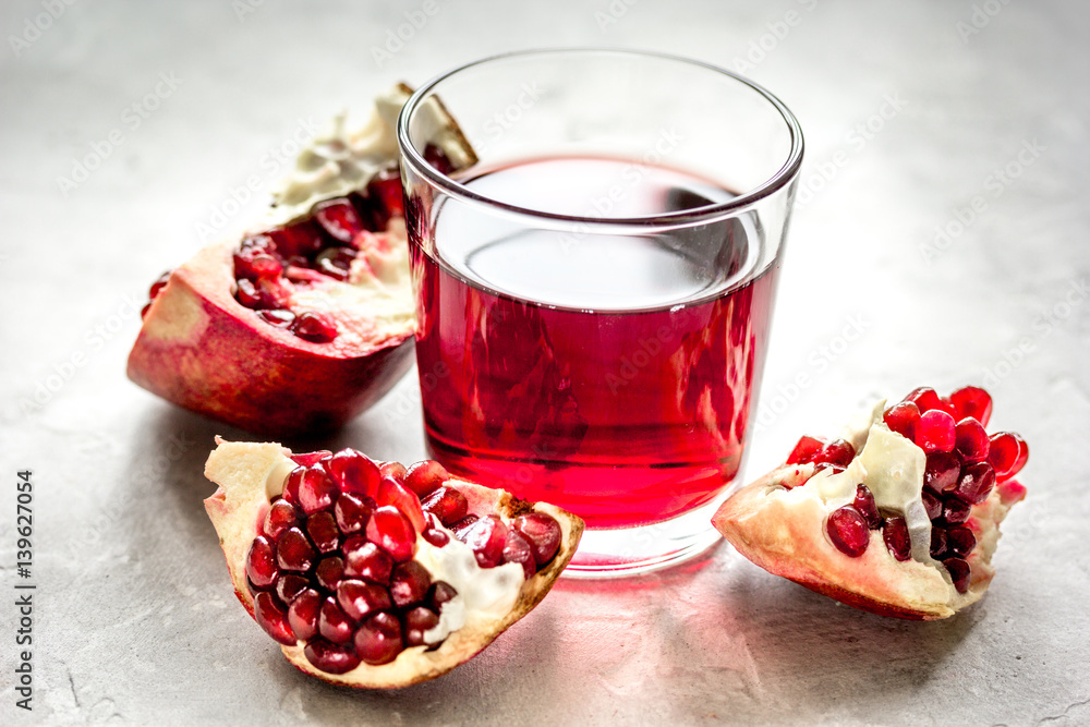 pomegranate juice with seed on stone table background pomegranate juice with seed on stone table background