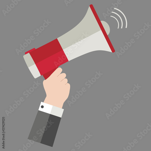 Megaphone in hand on a gray background