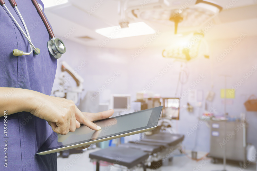 Female doctor,surgeon holding using tablet pc computer at work,Healthcare And Medicine,during the conference on blurred background ambulance speeding through the streets.in vintage color Female doctor,surgeon holding using tablet pc computer at work,Healthcare And Medicine,during the conference on blurred background ambulance speeding through the streets.in vintage color
