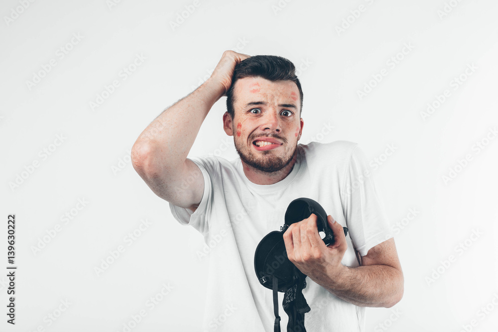 The guy is holding a woman's bra. The wife found her husband with another woman. Bustaltern mistress. Traces of kisses on the face. The guy is holding a woman's bra. The wife found her husband with another woman. Bustaltern mistress. Traces of kisses on the face.