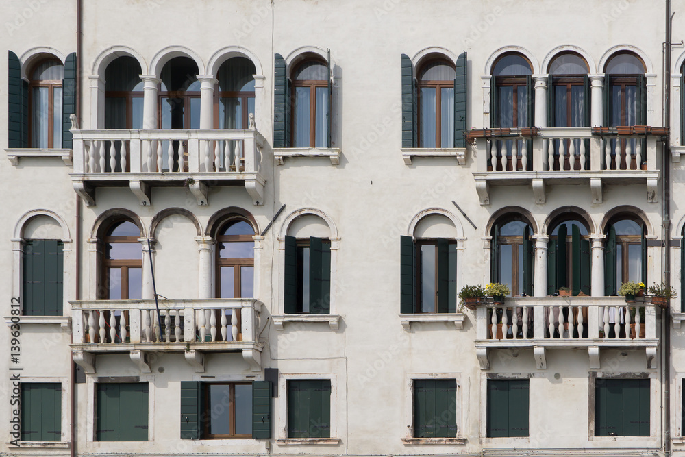 Beautiful ornate yellow building with balconies and sun awnings over windows, horizontal photo SWITZERLAND