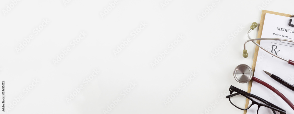 Fototapeta premium prescription, sterile doctors office desk. Medical accessories on a white background with copy space around products.Workplace of a doctor. Stethoscope, clip board, glasses and other things,banner