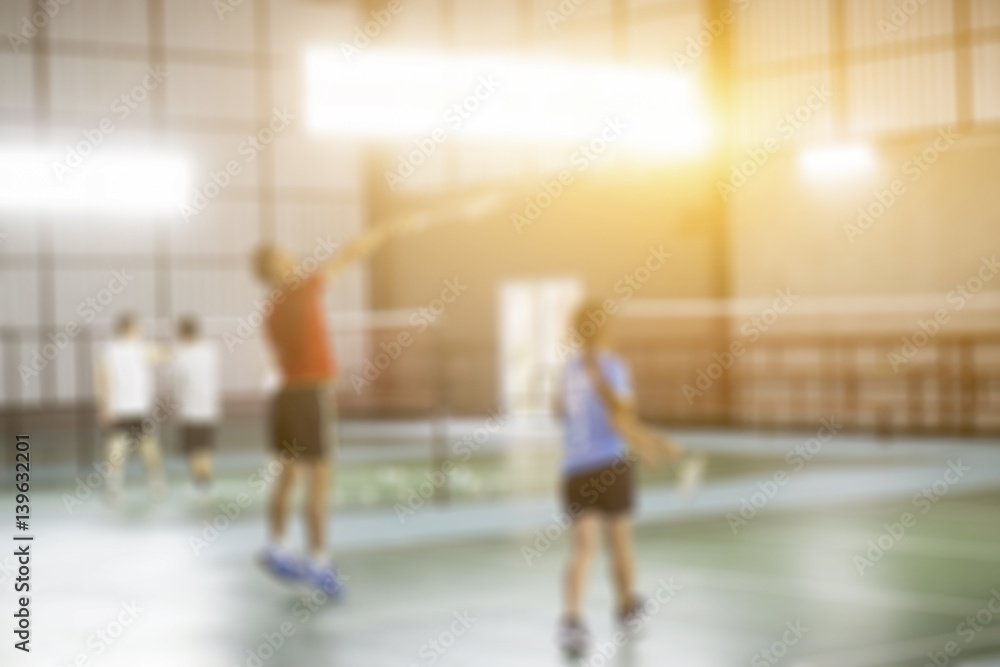  Blurred background of the shuttlecock and badminton courts with players competing in modern gym,vintage color
