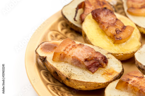 Baked potatoes with skin and bacon on it