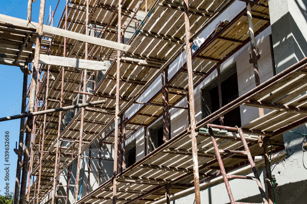 Metal scaffolding with wooden beams Metal scaffolding with wooden beams