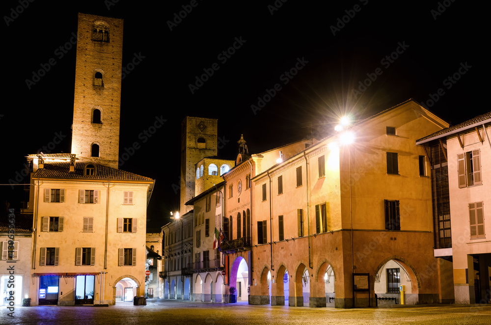 Piazza Risorgimento and the medieval towers of via Cavour, one of the main street of the town center of Alba (Piedmont, Italy) at night