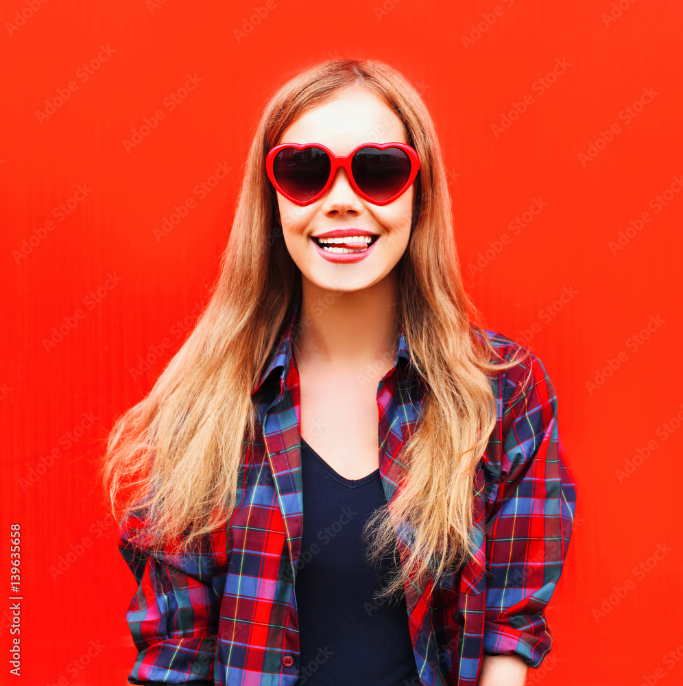 Portrait happy pretty young woman in red sunglasses shape of heart Portrait happy pretty young woman in red sunglasses shape of heart