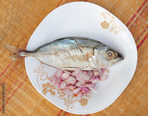 Fresh mackerels with onion in dish for cooking