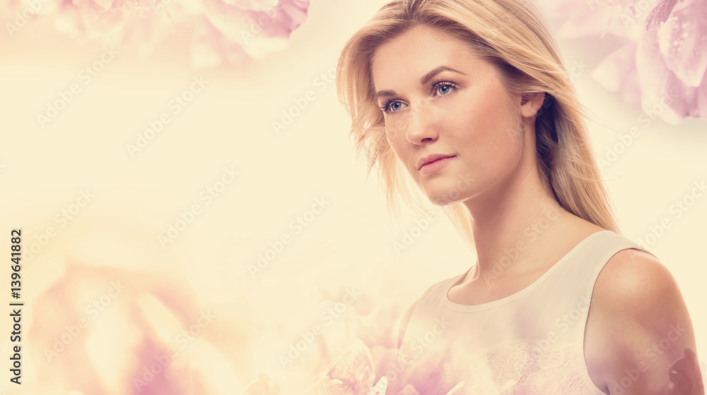 Young woman on a pink floral background Young woman on a pink floral background