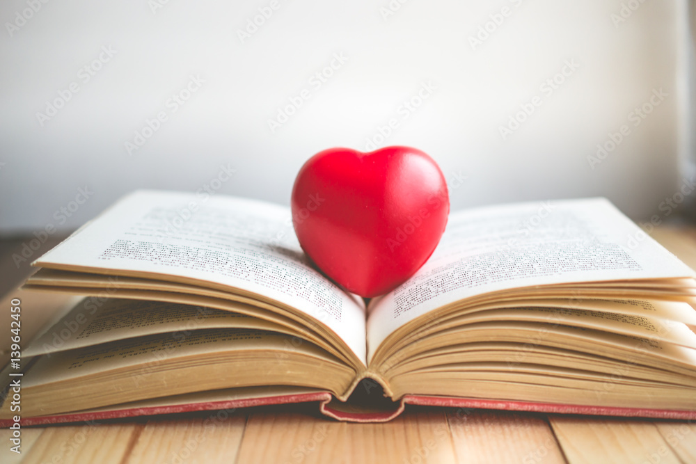 red heart on open book with copy space in relaxation and cozy mood, Image for education, love and brightness  concept