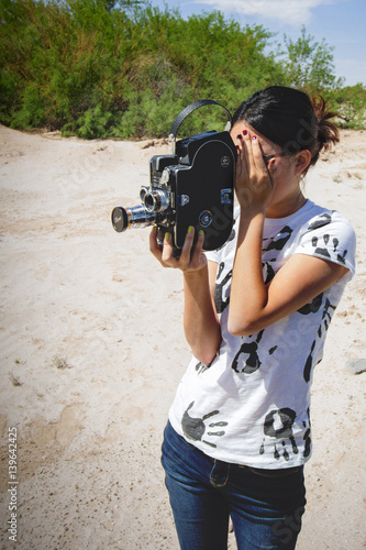 Girl Shooting 16mm Film Camera in Desert