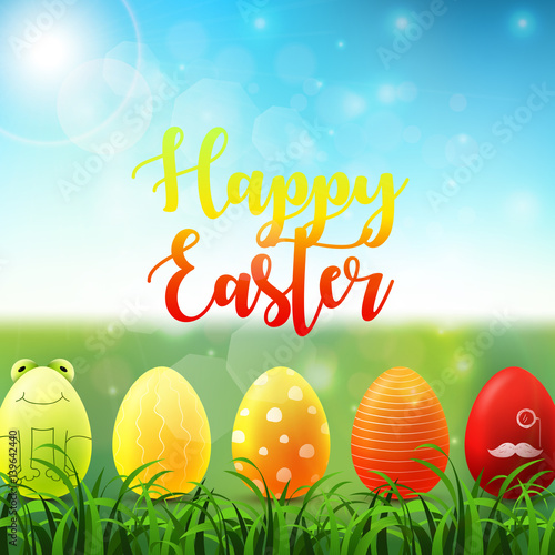 Easter background with bright easter eggs in the grass on sunny sky background