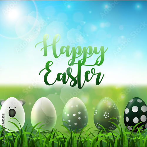 Easter background with easter eggs in the grass on sunny sky background