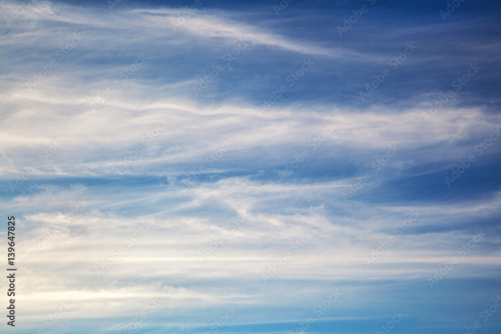 White wavy clouds on blue sky, background