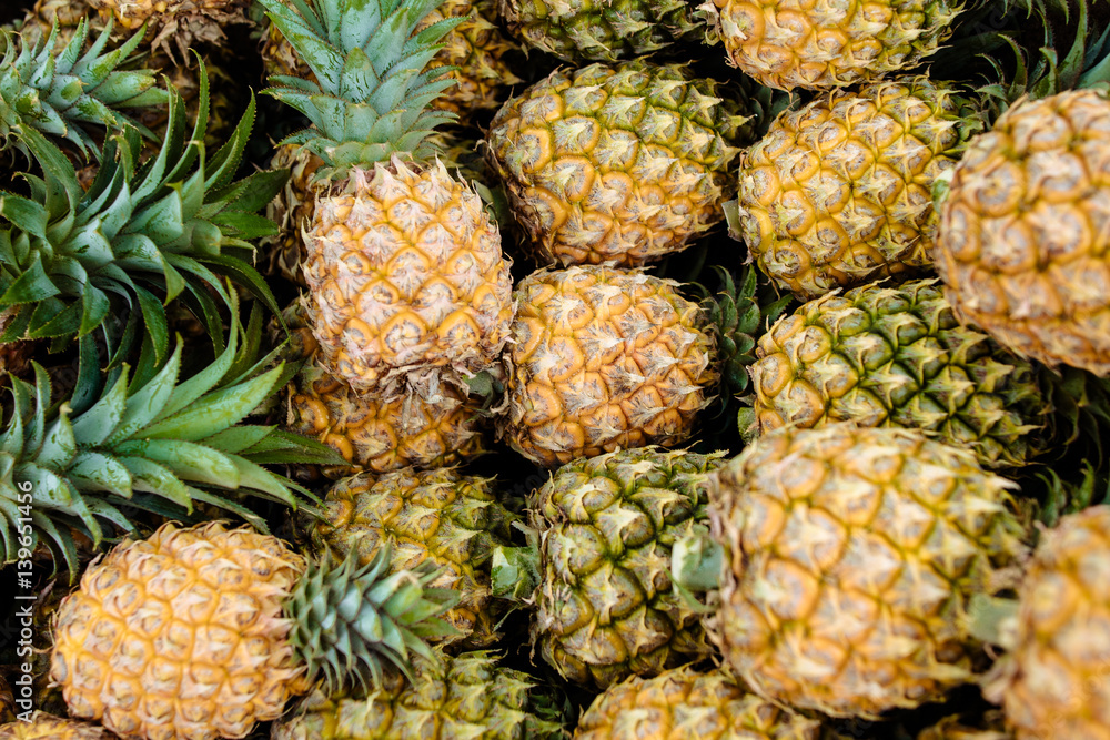 sweet Thai pineapples lie on a counter sweet Thai pineapples lie on a counter
