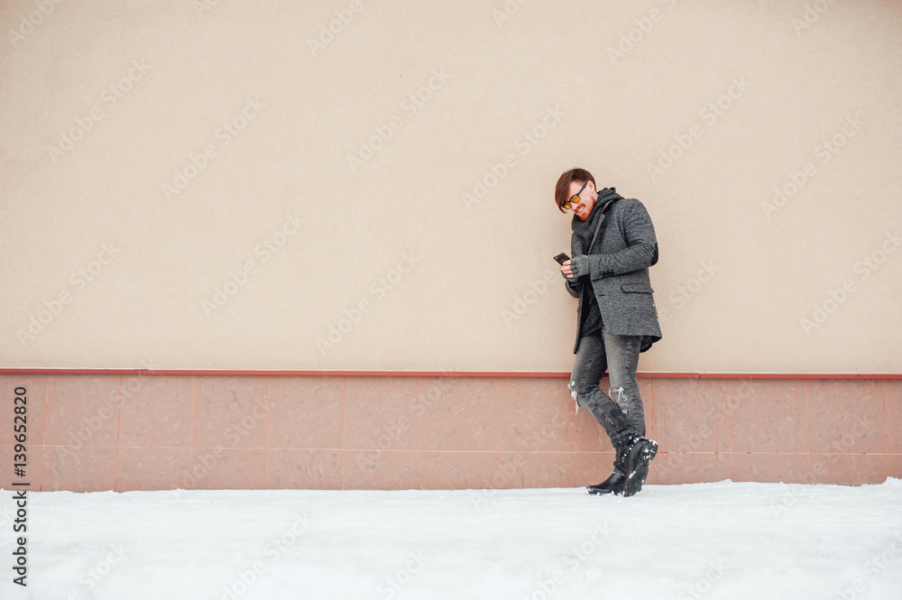 Stylish man in a coat on background of the house Stylish man in a coat on background of the house