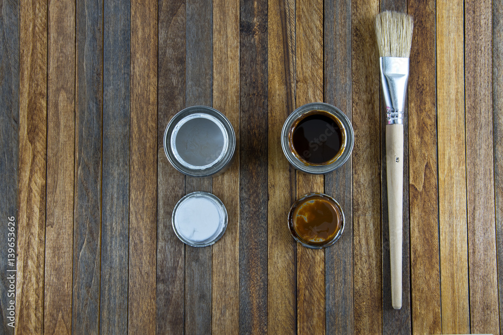 Home improvement, colorful paint cans on the clear wooden background Home improvement, colorful paint cans on the clear wooden background