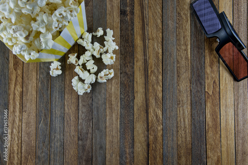 pop corn and 3d glasses  on wooden background