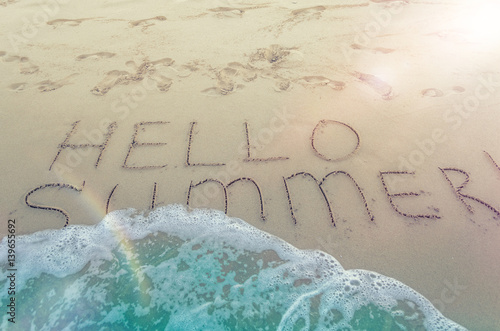 Hello summer written on the beach