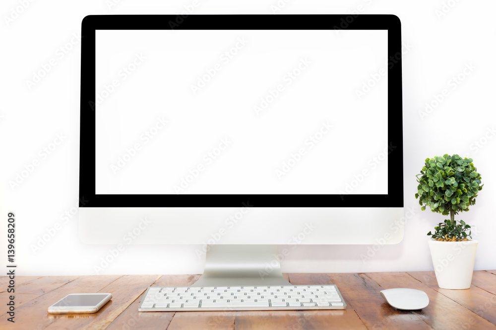 Office monitor computer, mouse on wooden table and white wall background Office monitor computer, mouse on wooden table and white wall background