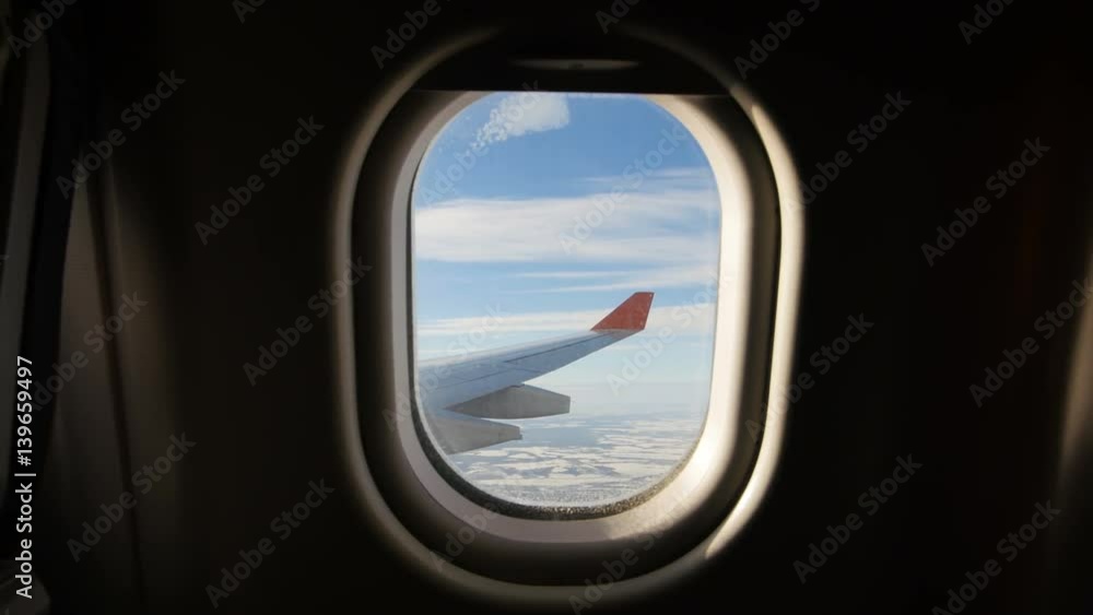Land seen through the window of jet airplane. Airplane slowly landing Land seen through the window of jet airplane. Airplane slowly landing
