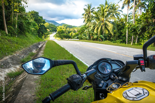 Open road and yellow motorbike on jungle road trip - Puerto Princesa, Palawan - Philippines