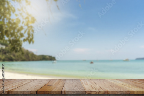 wood table top and blue sky with seascape background