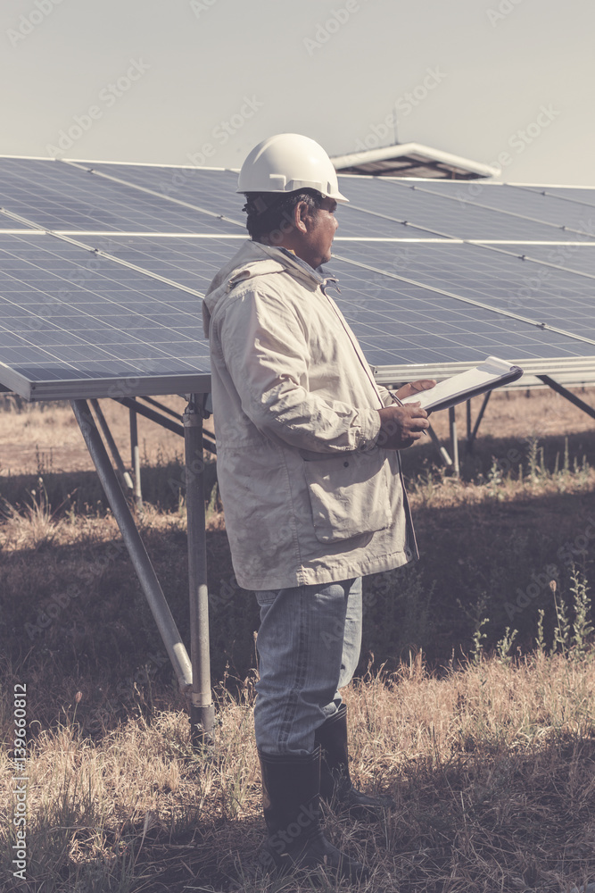 foreman checking job routine of labor working on cleaning solar panel at outside ; operation working on preventive and maintenance in solar power plant for great efficiency foreman checking job routine of labor working on cleaning solar panel at outside ; operation working on preventive and maintenance in solar power plant for great efficiency
