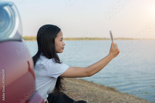 student woman sit down call smartphone at sunset