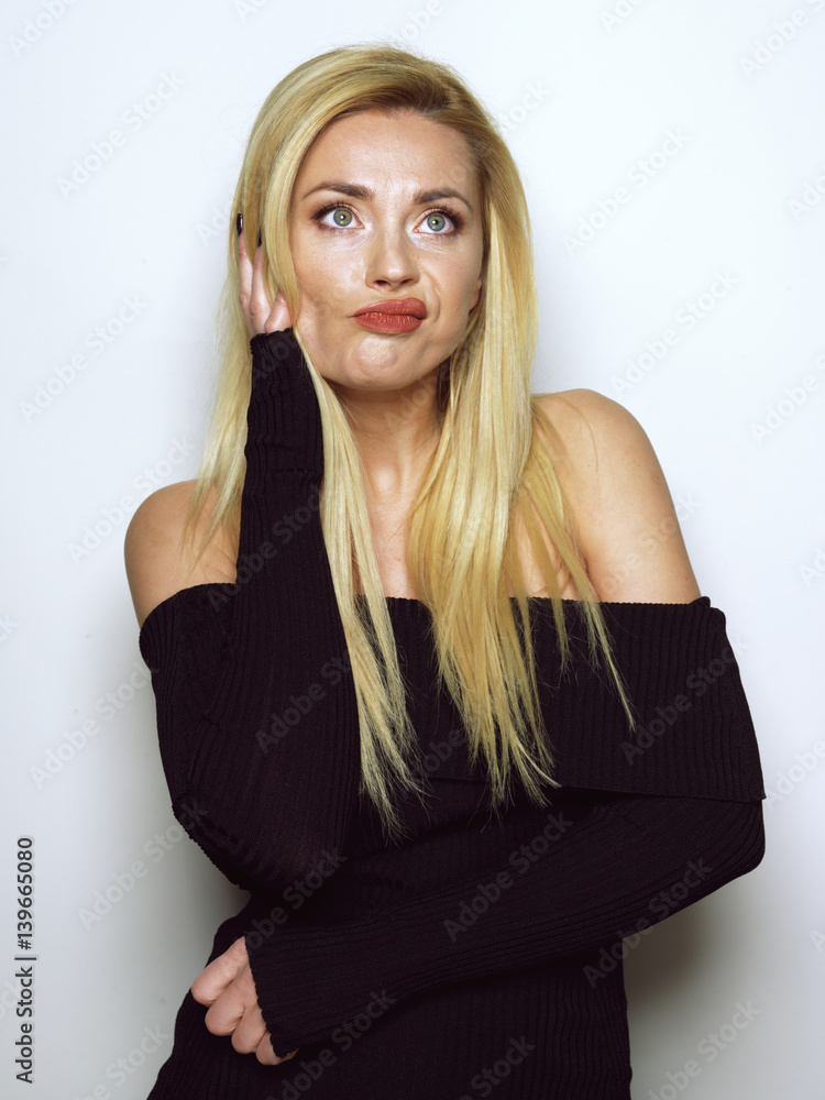 Beautiful blonde girl in a black dress. Beautiful blonde girl in a black dress.