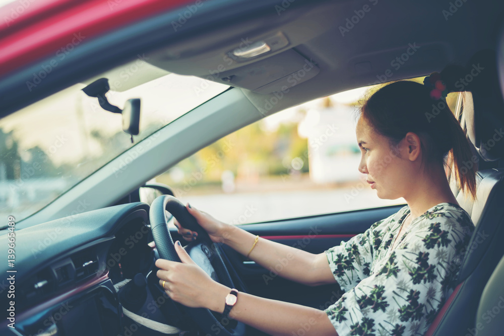 Fototapeta premium young woman happy in car