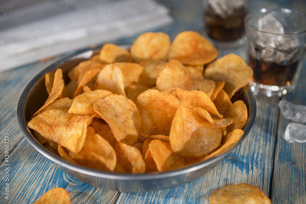 Crisps bowl on a wooden table close up Crisps bowl on a wooden table close up