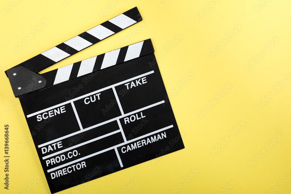 top view of movie clapper board on yellow