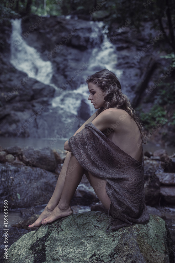 Portrait of a young woman meditating on the rock Portrait of a young woman meditating on the rock