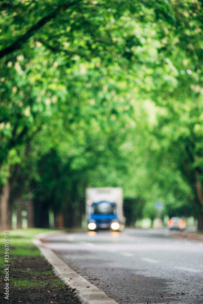 Blurred image of truck driving on asphalt road Blurred image of truck driving on asphalt road