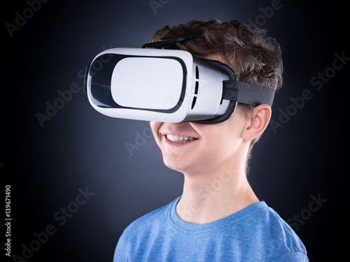 Teen boy in VR glasses © valiza14