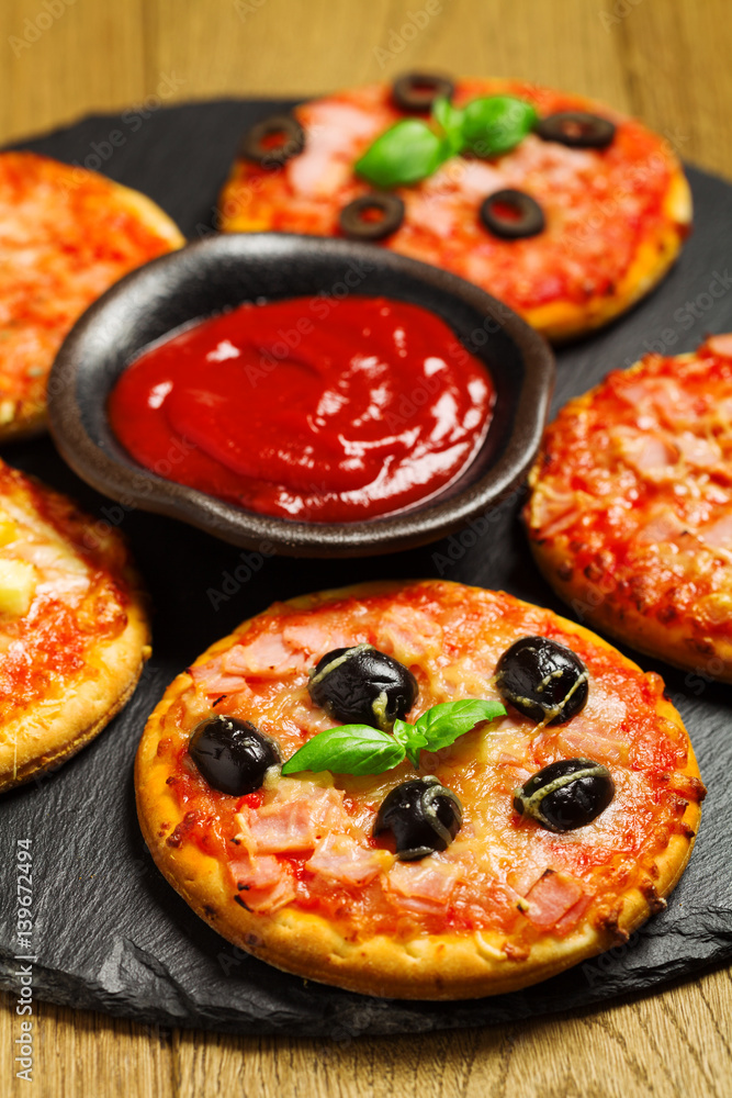 Mix of mini pizzas on a stone try Mix of mini pizzas on a stone try