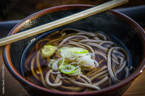 Close up of Soba Noodles with Negi, Spring Onions, Chopsticks.