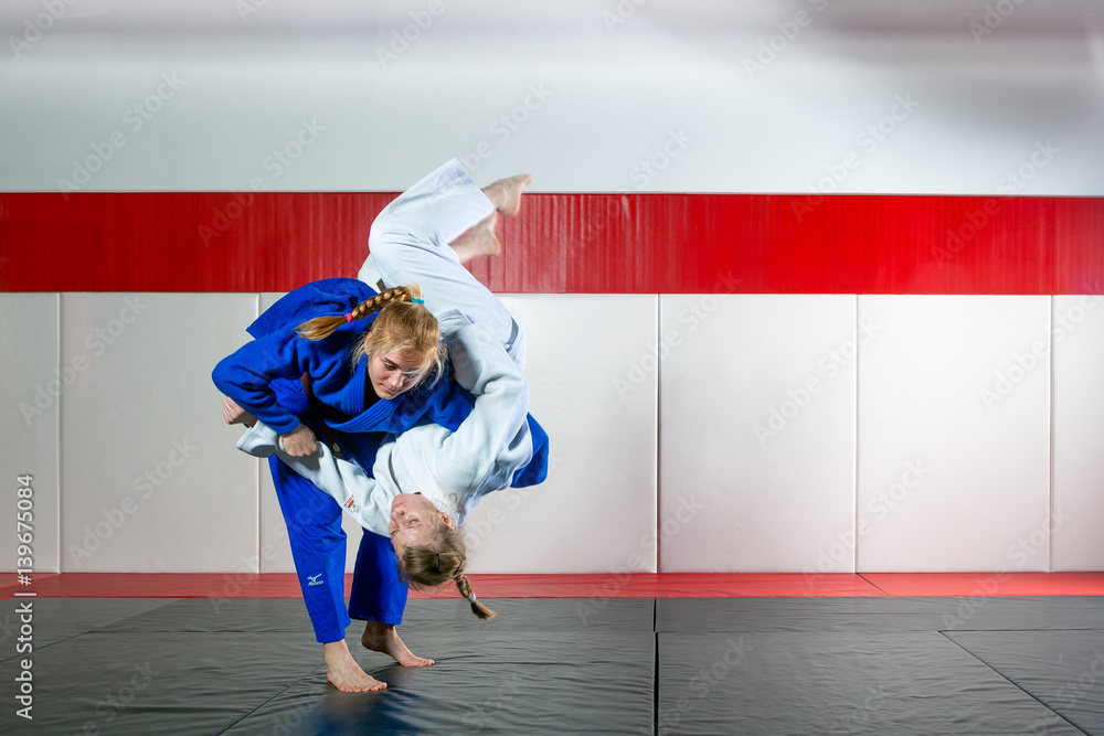 Two women fight judo on tatami Stock Photo