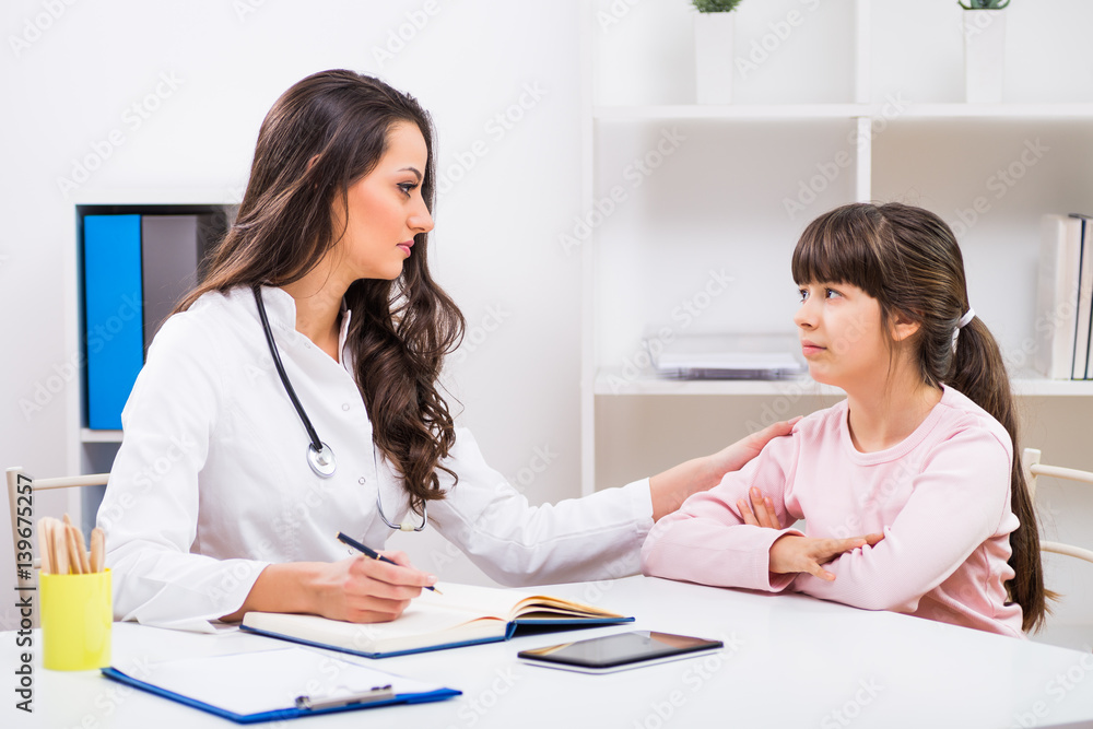 Female doctor consoling child at the medical office. Female doctor consoling child at the medical office.