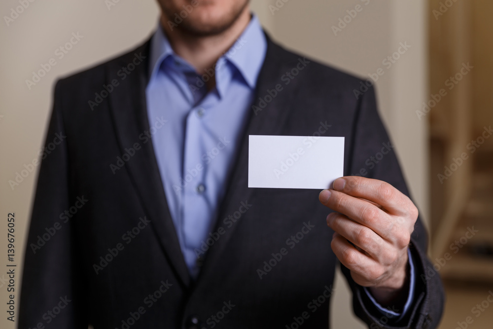 Businessman holding visit card. Man showing blank business card. Person in black suit. Mock up design. Businessman holding visit card. Man showing blank business card. Person in black suit. Mock up design.